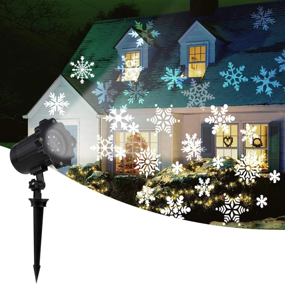 LED Christmas snowflake laser projector with white snowfall pattern on a garden lawn at night