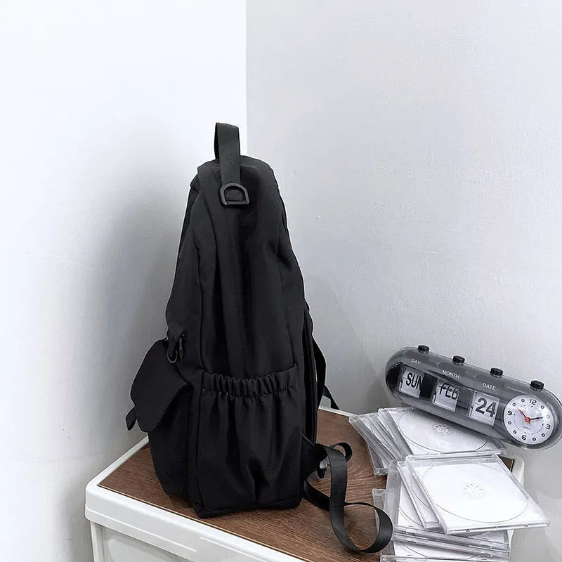 Nylon backpack school bag for junior high students, waterproof, lightweight, available in black, blue, pink, and white colours