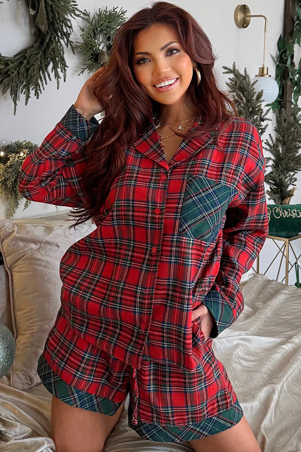 Red plaid Christmas pyjama set for adults, featuring a long sleeve shirt and shorts with contrast patches.