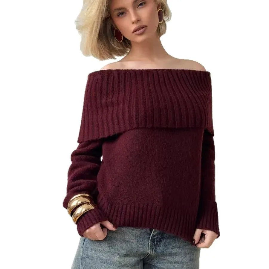 Grey off-the-shoulder acrylic sweater with a textured 3D pattern on a hanger.