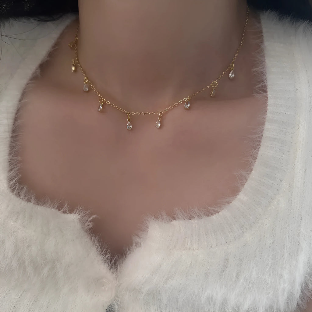 Women's zircon necklace, earrings, and anklet set with geometric meteor shower design.
