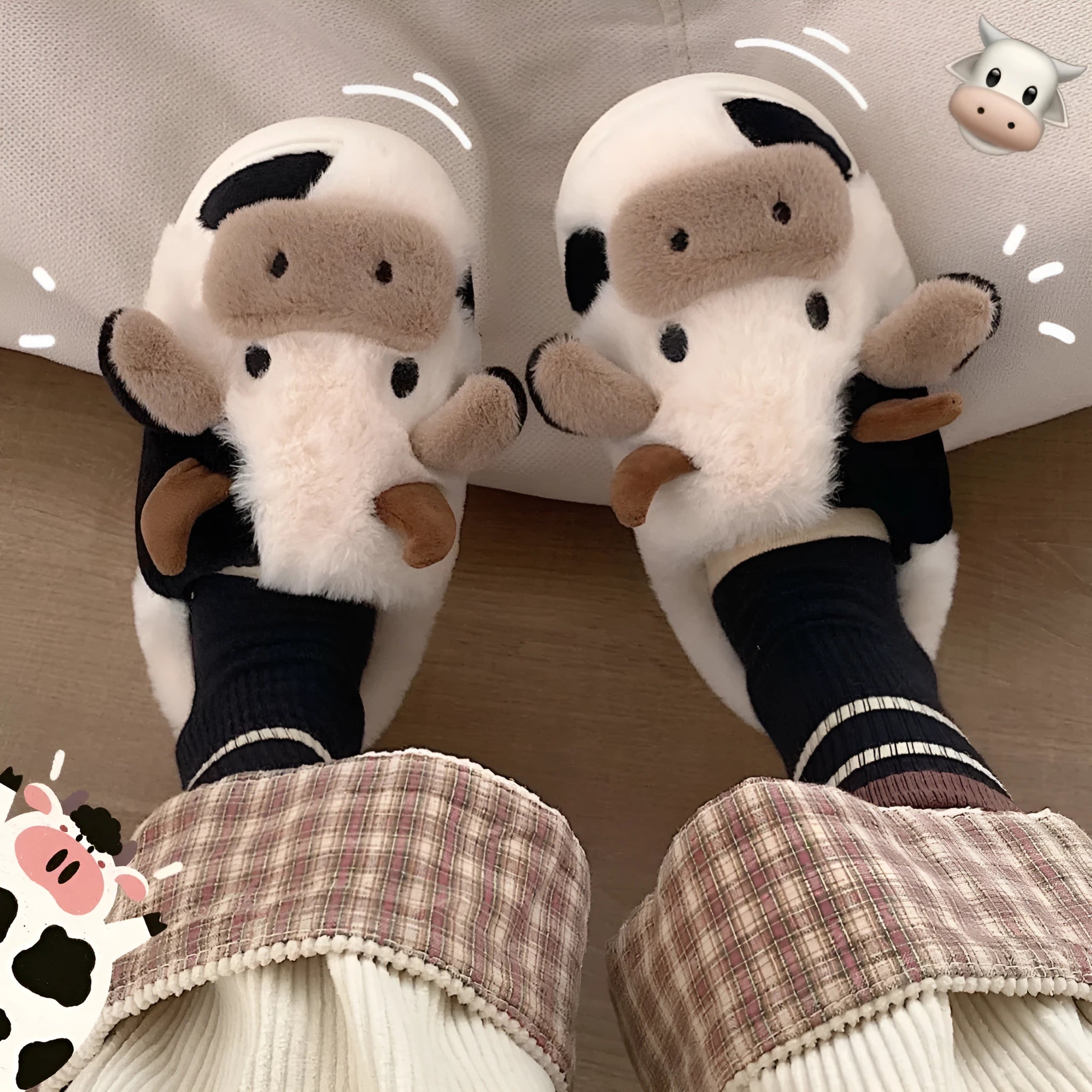 White cow-themed faux fur slippers with black spots and a textured grey anti-slip sole.