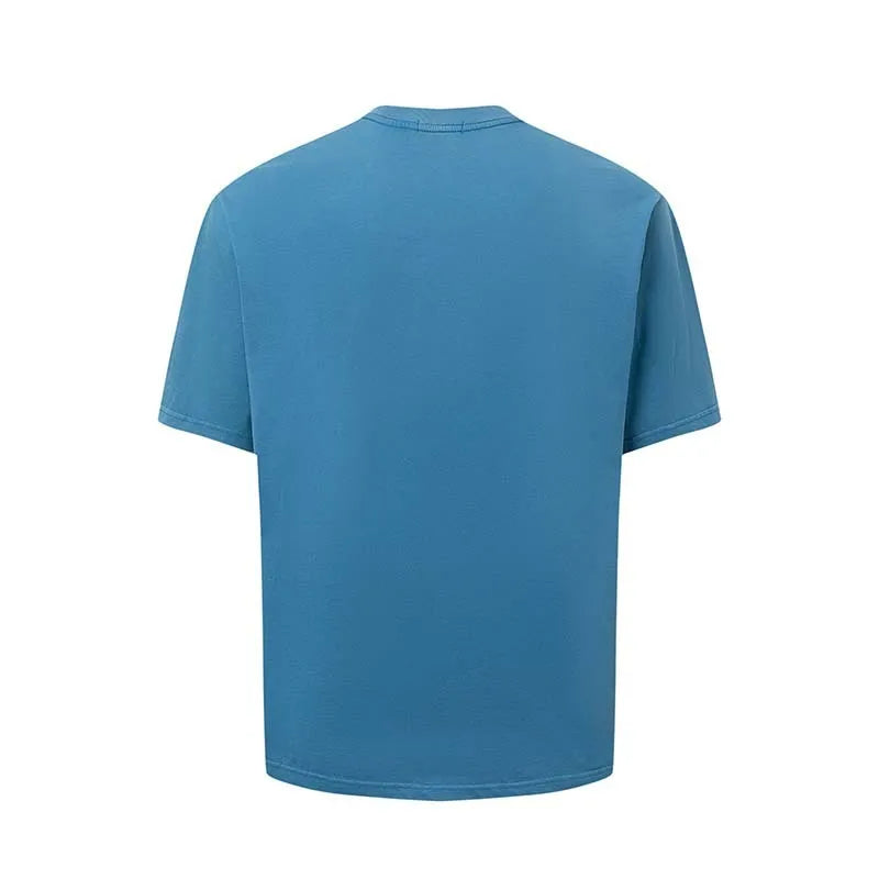 Man wearing a blue loose-fit cotton blend T-shirt with a retro white letter print design on the chest.