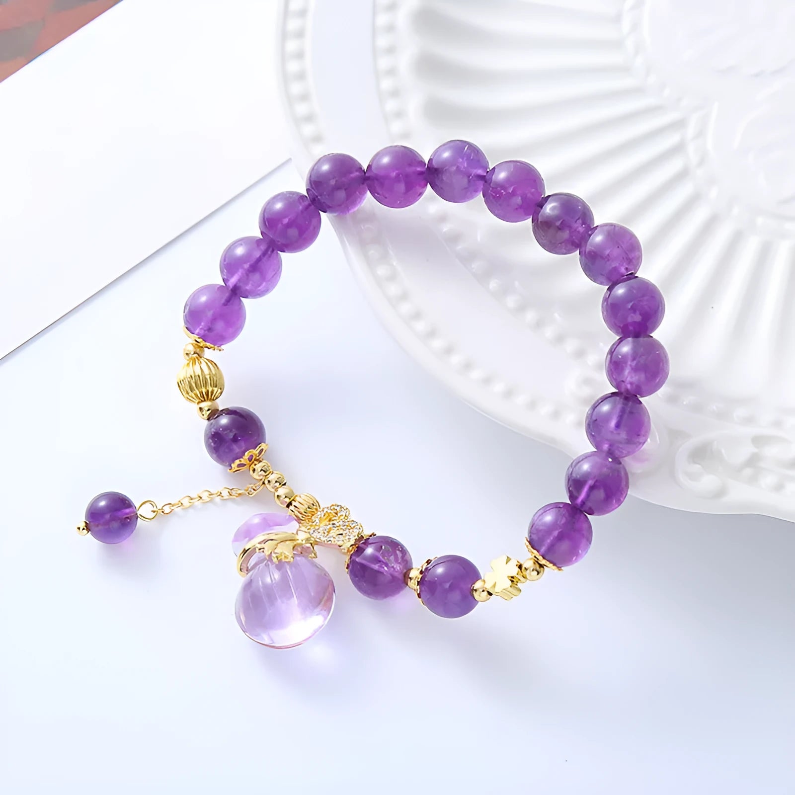 Purple amethyst bracelet with ethnic money bag pendant and peace buckle closure on wrist
