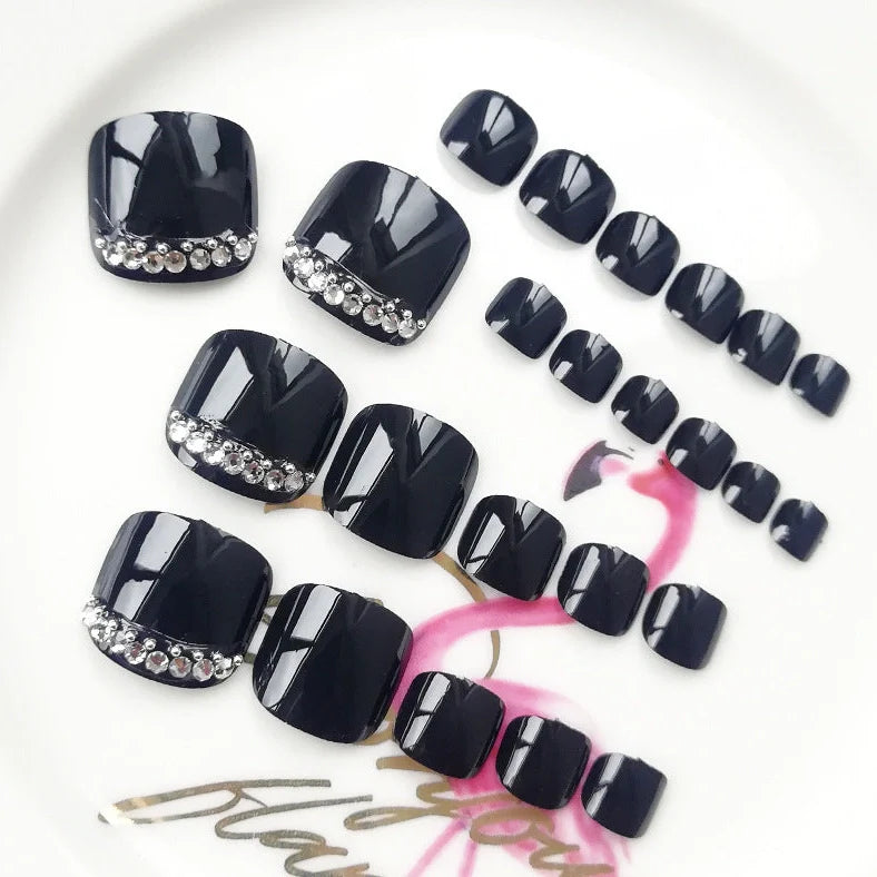Black rhinestone toe nail patches with geometric and floral designs on adhesive backing