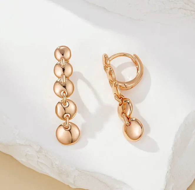 Gold tone retro long circle earrings with woven texture on a copper base.