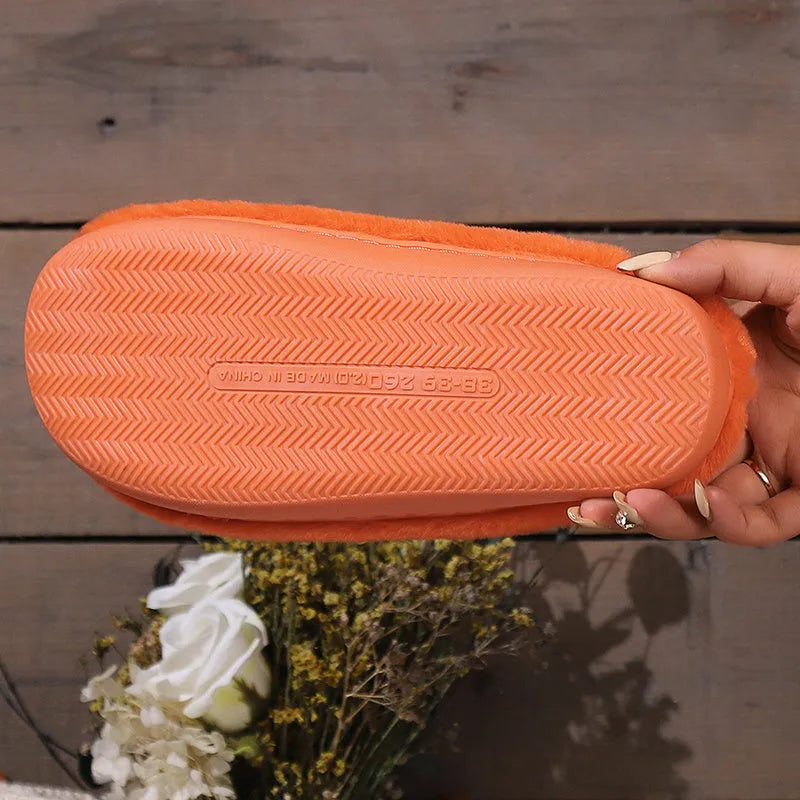 Orange Halloween pumpkin slippers with plush interior and non-slip PVC sole