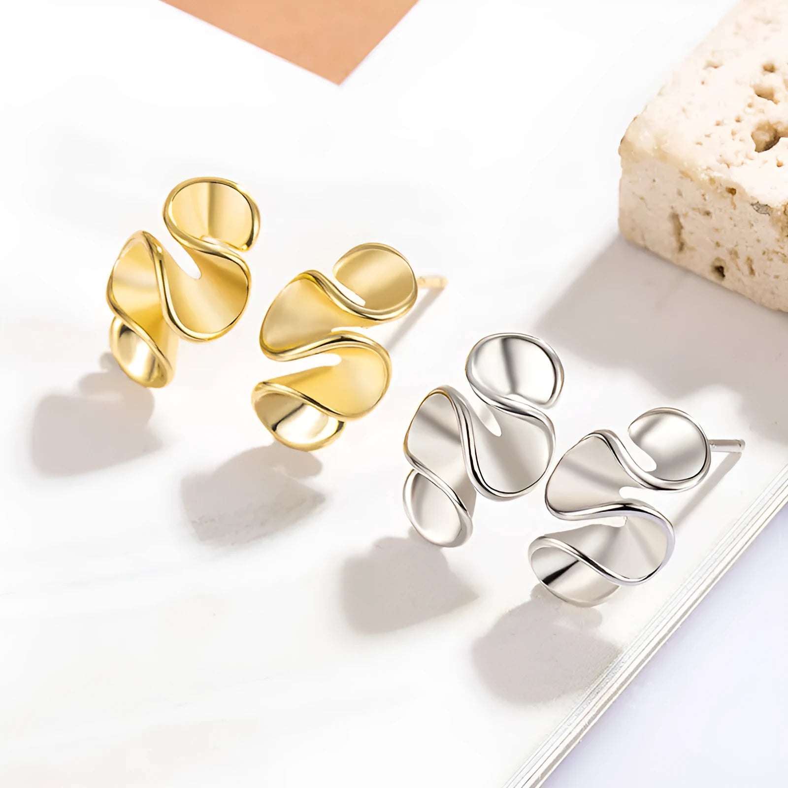 Geometric cream flower stud earrings in gold electroplated finish on copper base with irregular shape