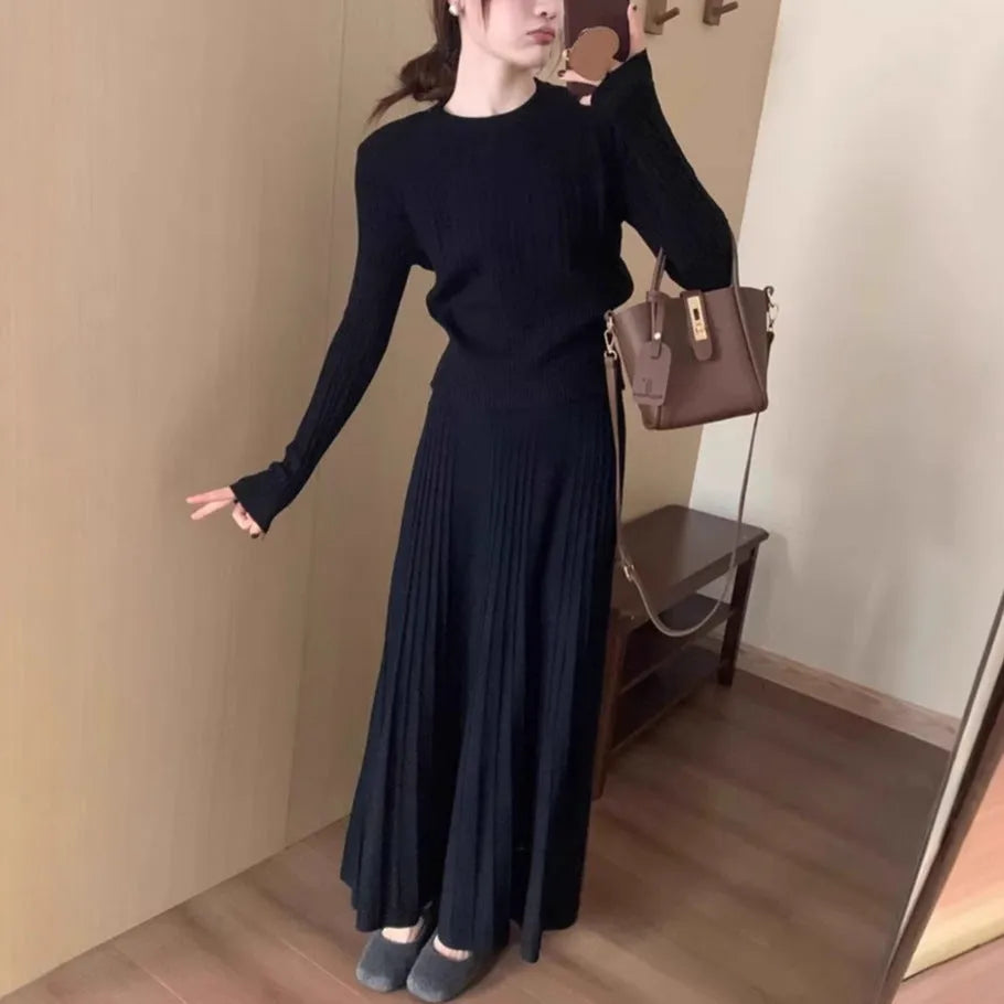 Dark grey knitted dress suit set with 3D pattern, featuring a sweater and skirt.