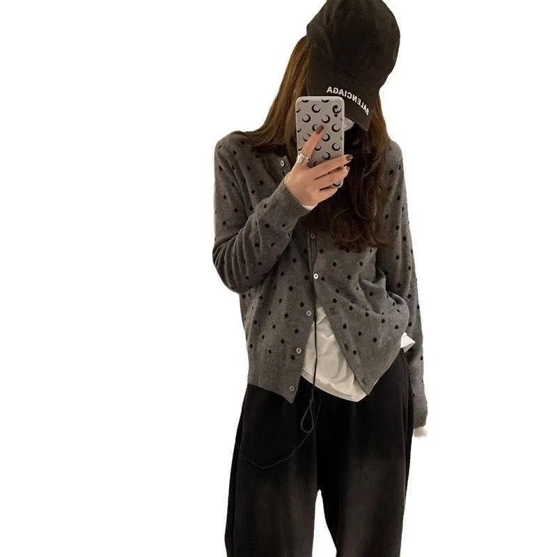 Women's loose grey knitted cardigan with crocheted dot flowers, long sleeves.