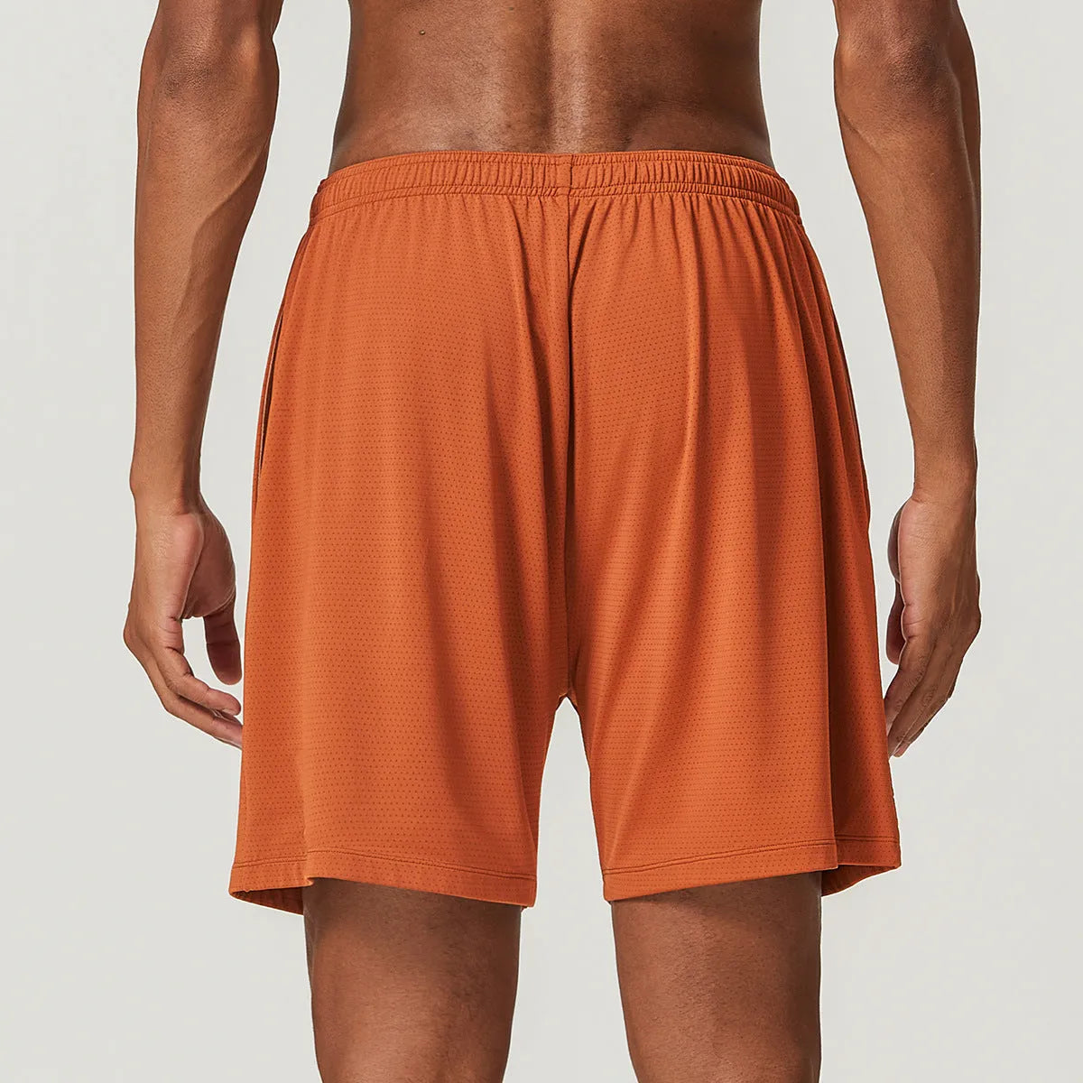 Men's quick-drying double-layer running shorts in sky green colour, laid flat to show mid-waist fit and shorts length.