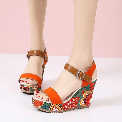 Women's floral embroidered wedge sandals in black, green, and orange with buckle strap