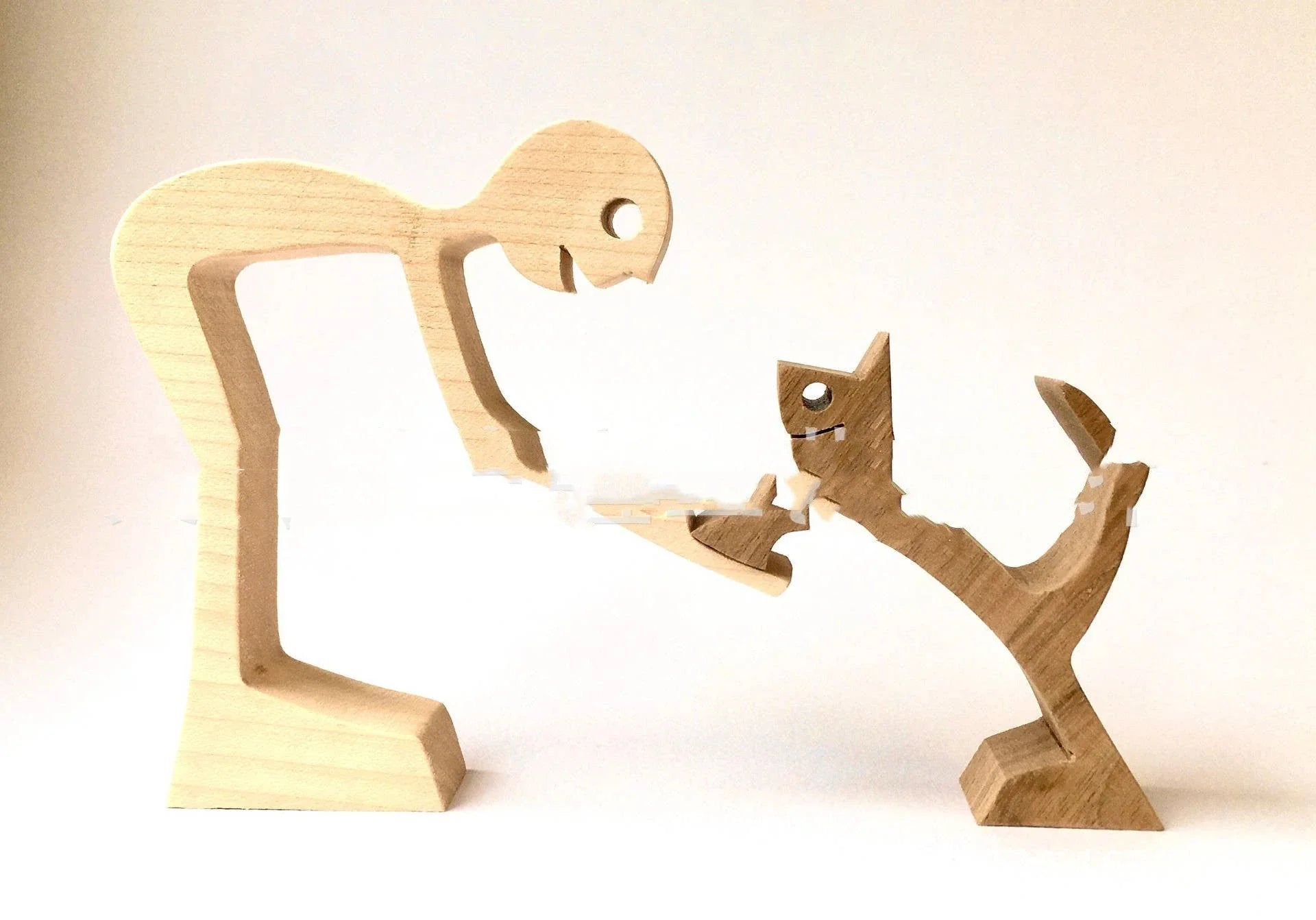 Handcrafted wooden dog sculpture featuring a man and his loyal canine companion