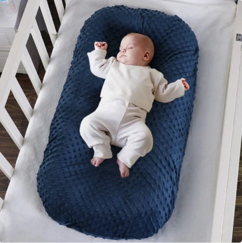 Newborn bionic nap bed in blue and yellow, featuring anti-pressure design and washable fabric