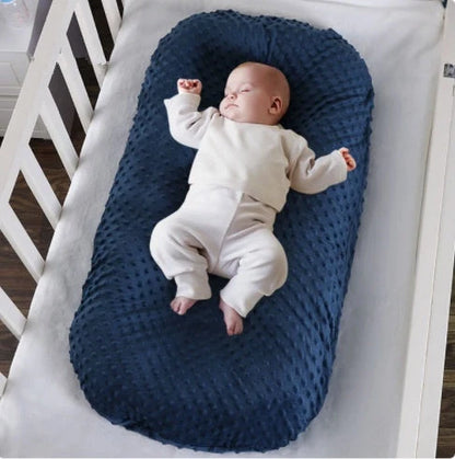 Newborn bionic nap bed in blue and yellow, featuring anti-pressure design and washable fabric