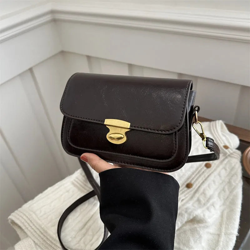 Small soft PU leather square handbag in retro design, shown in a neutral colour.