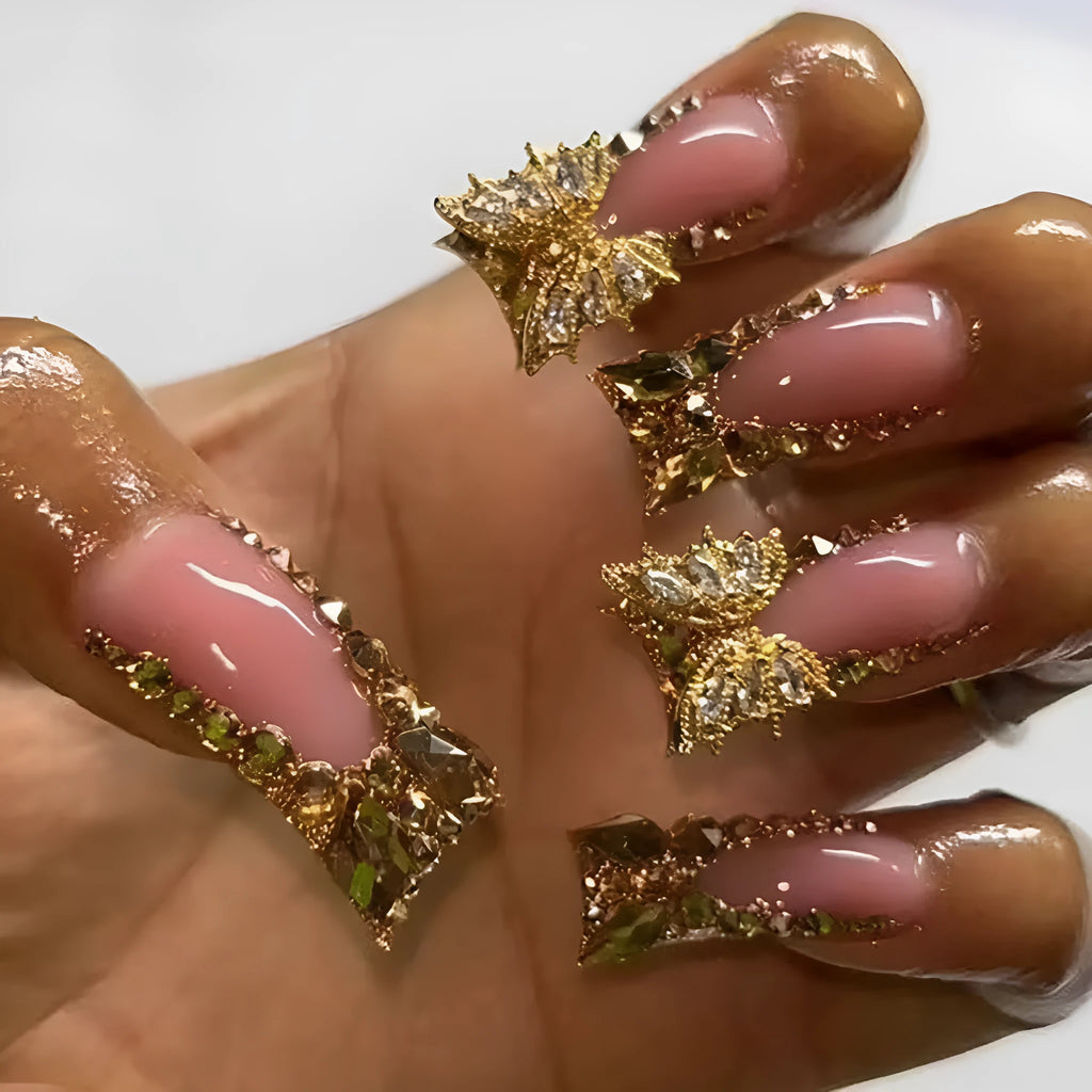Golden diamond and butterfly design nail stickers on nails with debris texture, part of a 24-piece DIY kit.