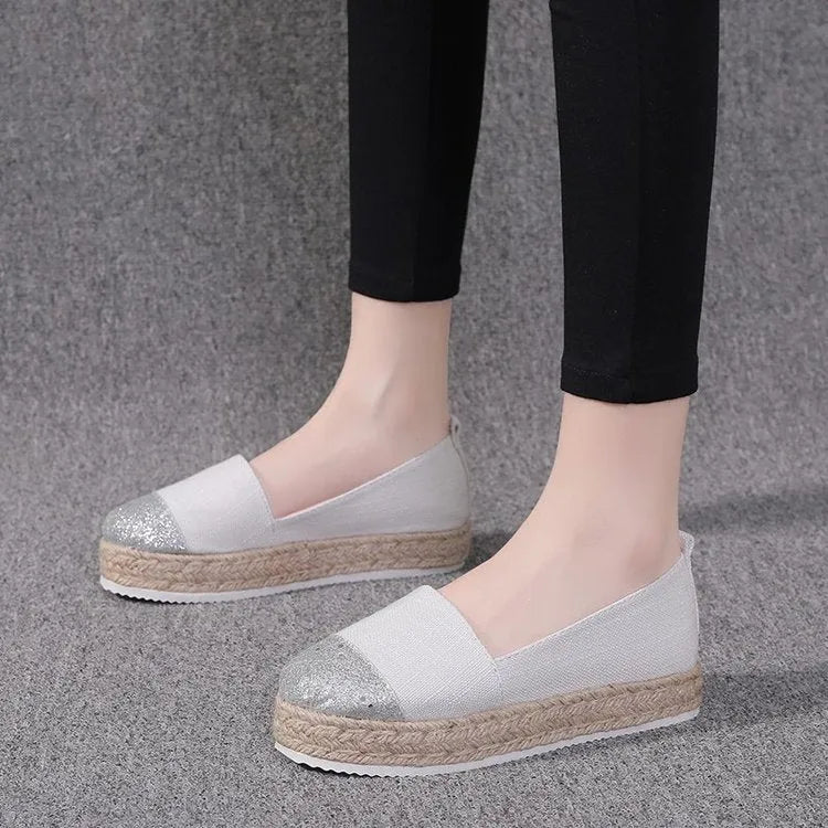 Black plus size breathable canvas flat shoe with round toe and slip-on design.