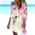 Close-up of a women's slim-fit blouse with a detailed 3D bird and flower digital print on a cardigan-style sleeve.