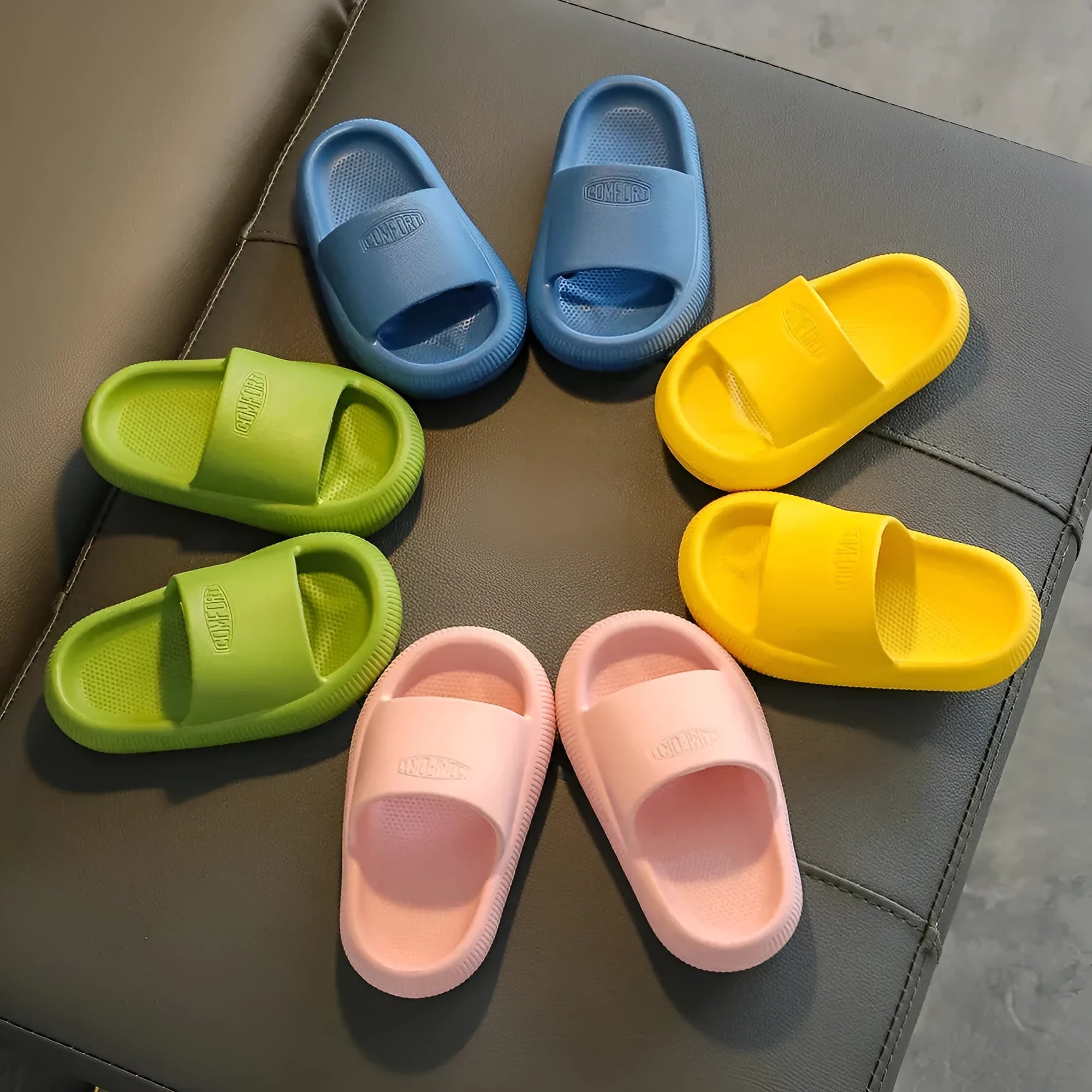Children's colourful EVA slippers with a non-slip sole, shown in blue, green, orange, pink, and yellow.
