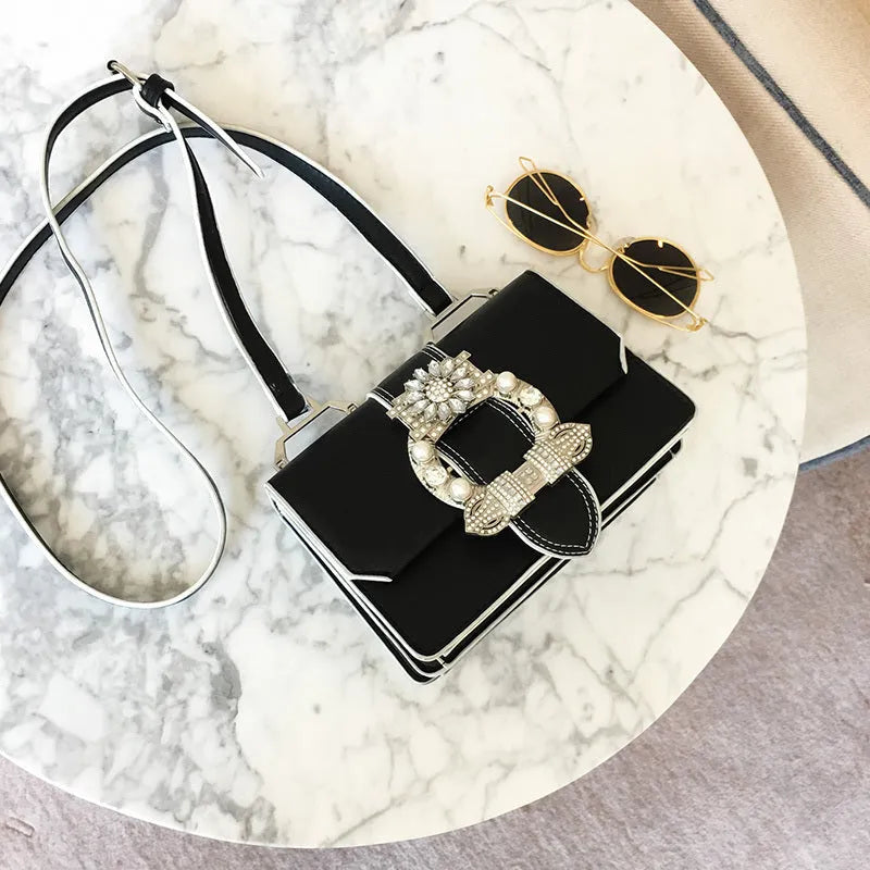 Women's designer diamond lock shoulder bag in quality PU leather, available in Black and Blanco colour options