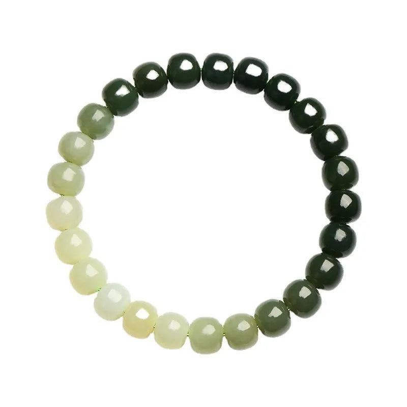 Natural Hetian jade bracelet with clear water gradient colour on wrist, showing polished beads.