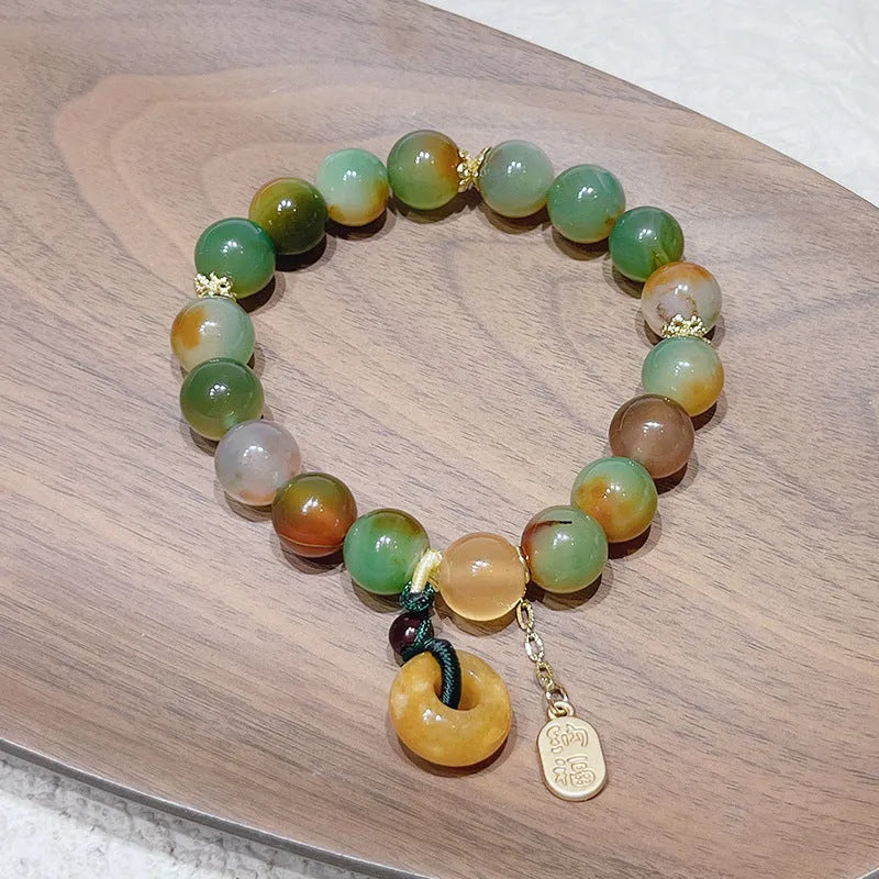 Yellow women's folk bracelet with peacock agate and topaz stones and a peace buckle clasp.