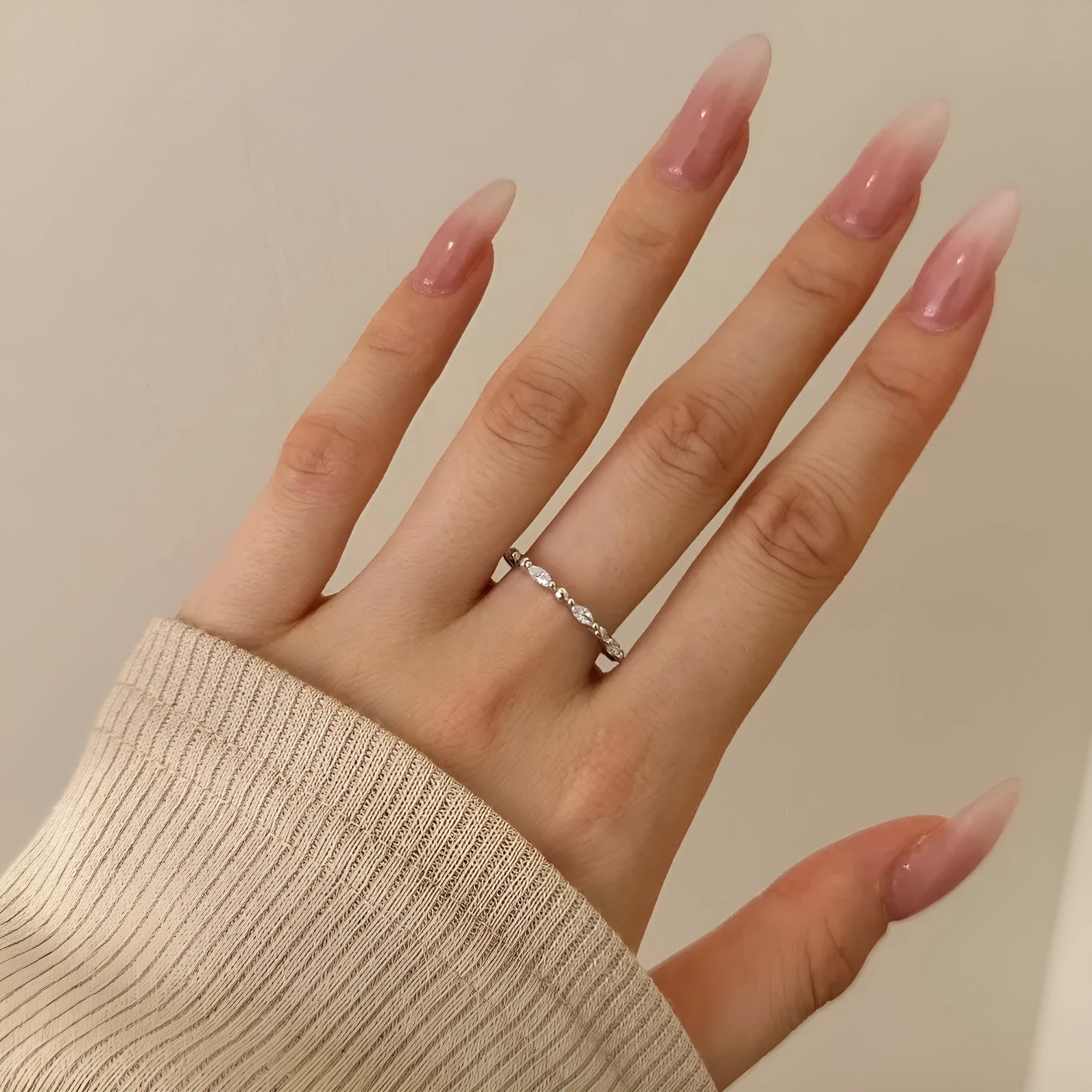 Silver rhombus ring with electroplated platinum finish on white background
