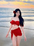 Red women's bikini swimsuit with puff sleeve skirt top and briefs.