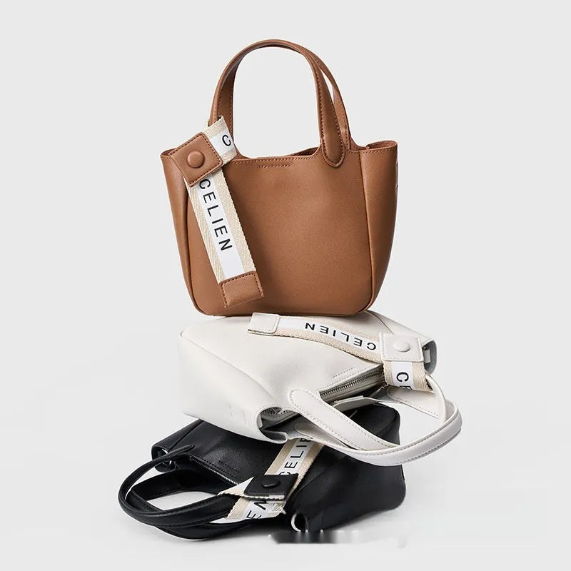 Brown genuine cattlehide leather cross body bucket bag showing sewing thread detail and slit pocket.