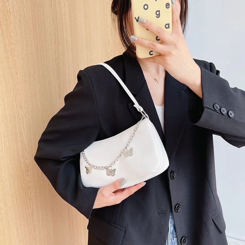 Women's black PU leather crossbody bag with butterfly chain strap and mobile phone pocket