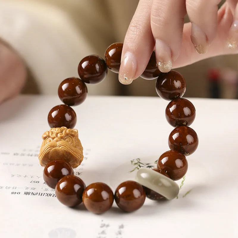 Ivory nut lion style round bead bracelet with 13mm natural seed beads in hand-woven construction