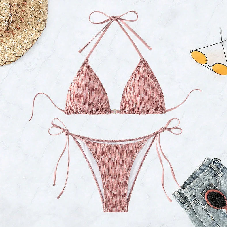 Green backless halter swimsuit with adjustable straps and matching shorts on mannequin