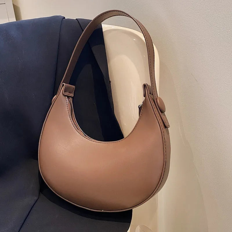 Retro dumpling-shaped women's shoulder bag in PU leather, shown in a choice of four colours.