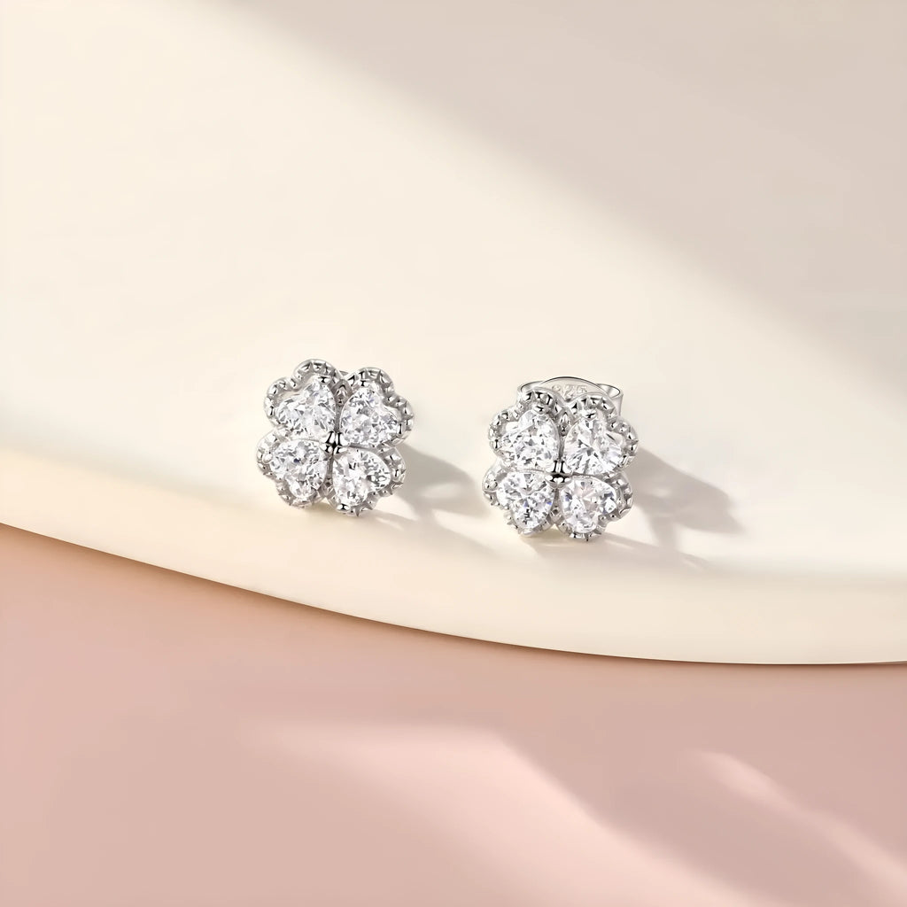 Women's sterling silver heart-shaped earrings with a four-leaf clover design and zircon stones.