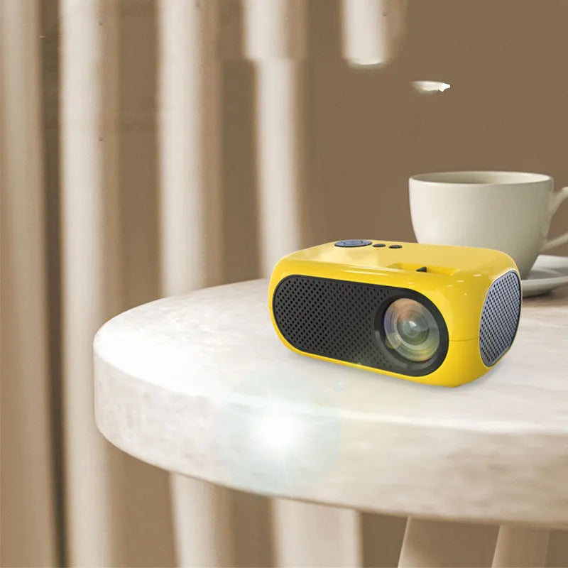 M24 micro mini LED projector in gold or white colour with compact design showing power adapter and AV cable accessories