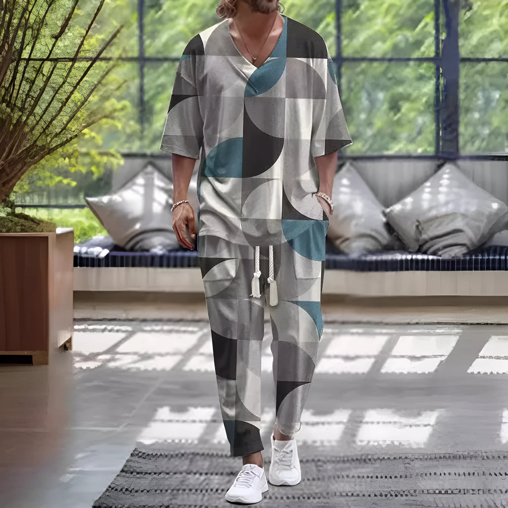 A person wearing a V-neck cropped sleeve jacket and matching trousers in a light colour.