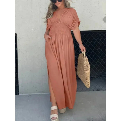 Stylish summer dress featuring unique bat sleeves, v-neck, slit design, and elastic waist for a flattering fit