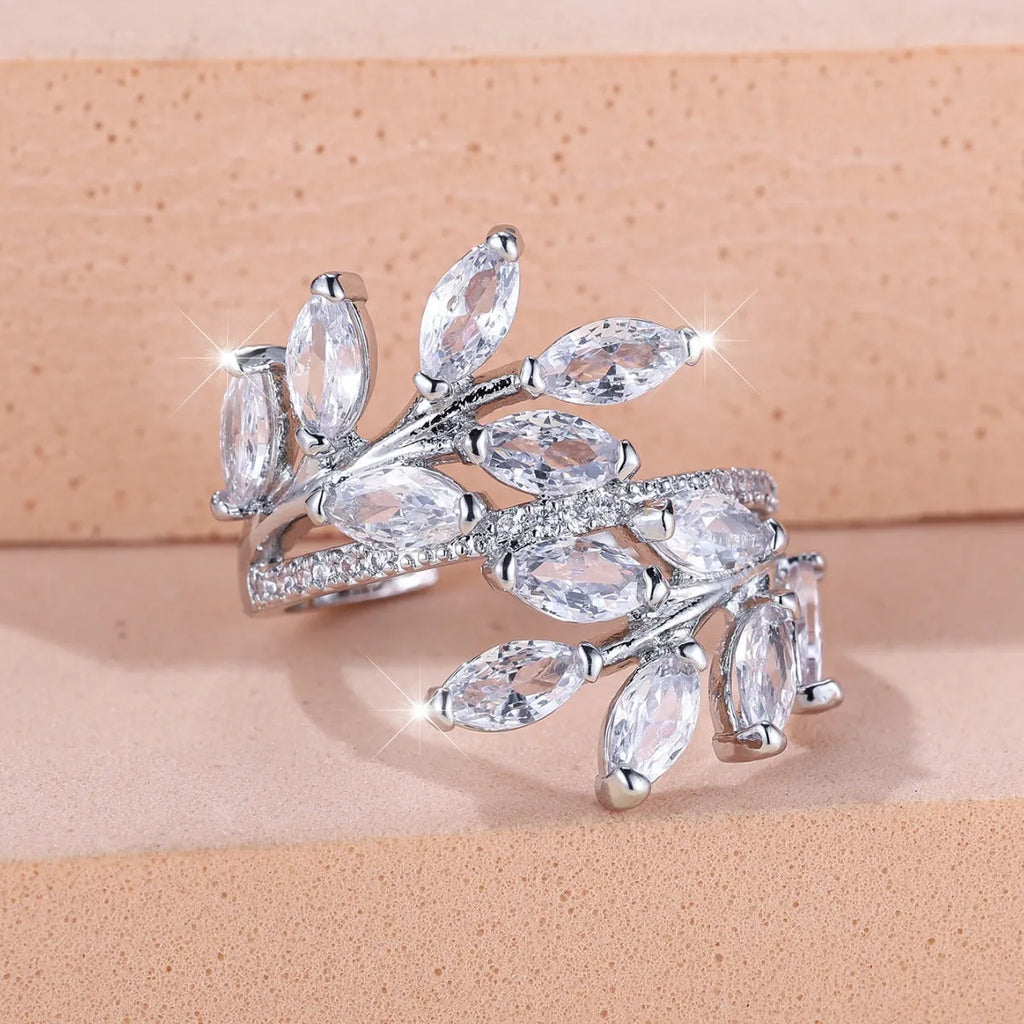 Adjustable copper leaf ring with a zircon stone in a choice of rose gold or platinum finishes.