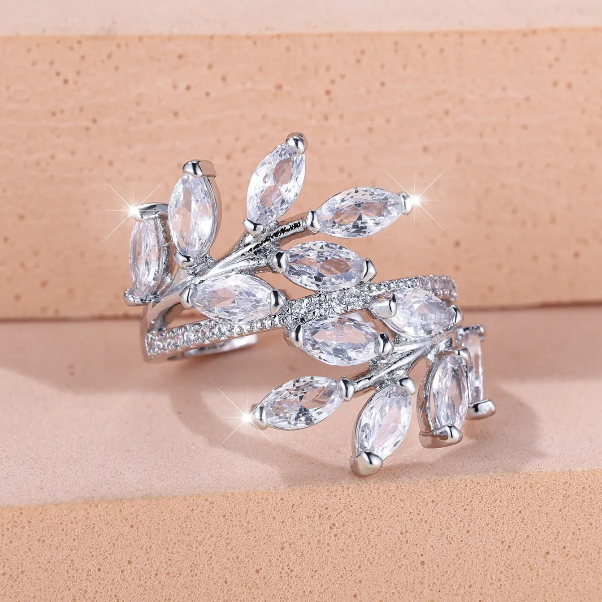 Adjustable copper leaf ring with a zircon stone in a choice of rose gold or platinum finishes.