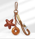 Handmade brown bread-themed handbag pendant charm with cartoon croissant, bagel, star, berry, and alkaline knot designs.