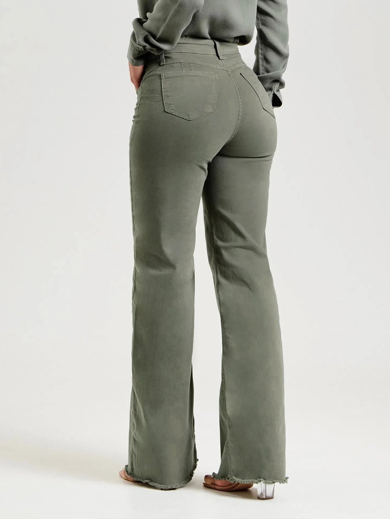 Slim fit stretch denim flared pants in olive green with a mid-waist design and zipper detail