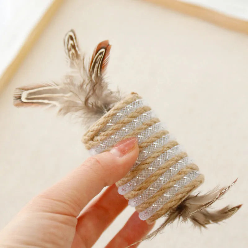 Beige cat toy with hemp rope scratching surface, attached feathers, and a roller for claw grinding.