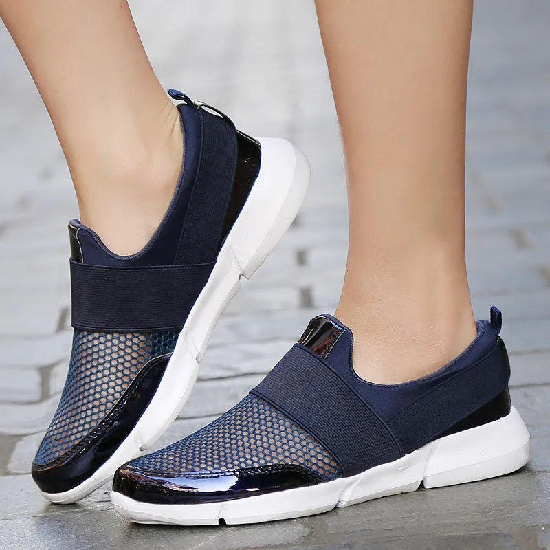 Blue low-top women's mesh sneakers with a colour-matching pattern on a light background.