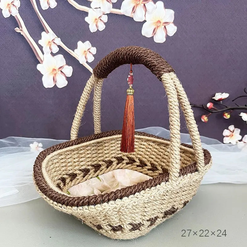 Coffee brown straw basket with hand-woven hemp rope detailing, shown on a wooden table.