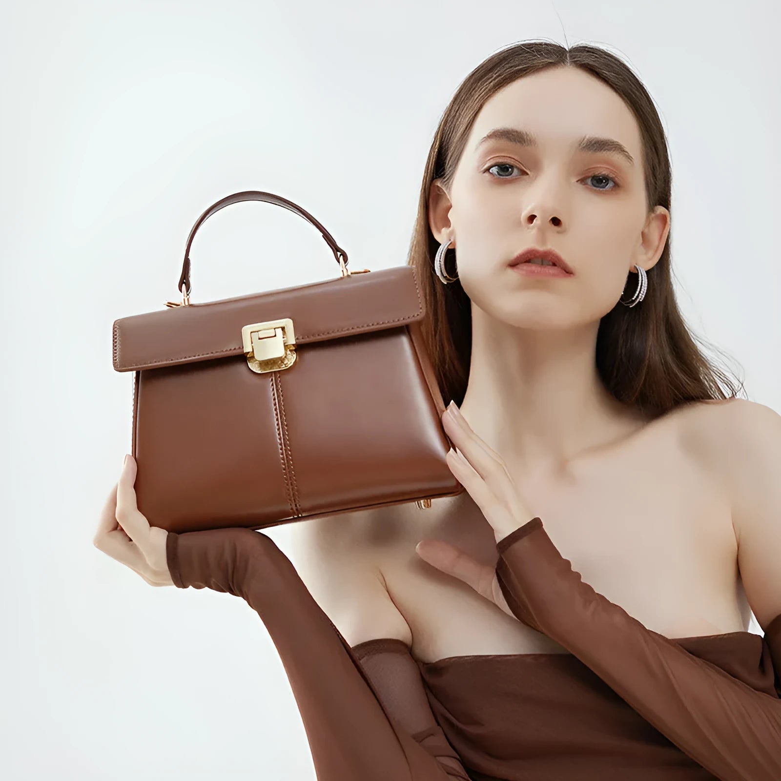 Black genuine leather women's shoulder bag with vachette clasp and long strap.