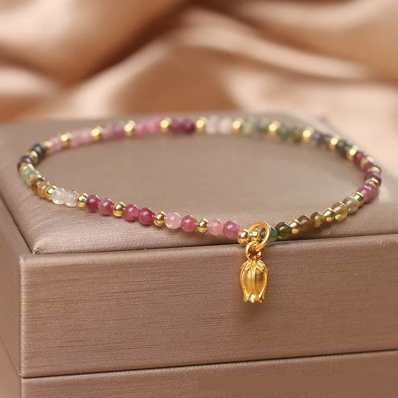 Green tourmaline floral bead anklet with adjustable chain on woman's ankle