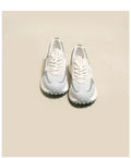 Women's low-top retro sneaker in grey or pink with round toe and rubber sole.