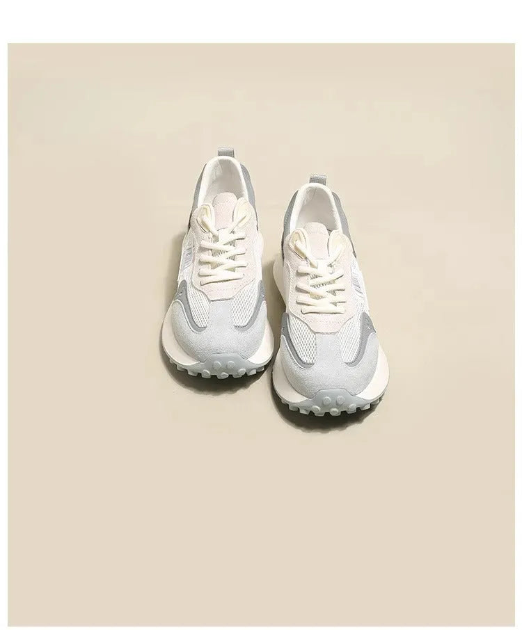 Women's low-top retro sneaker in grey or pink with round toe and rubber sole.