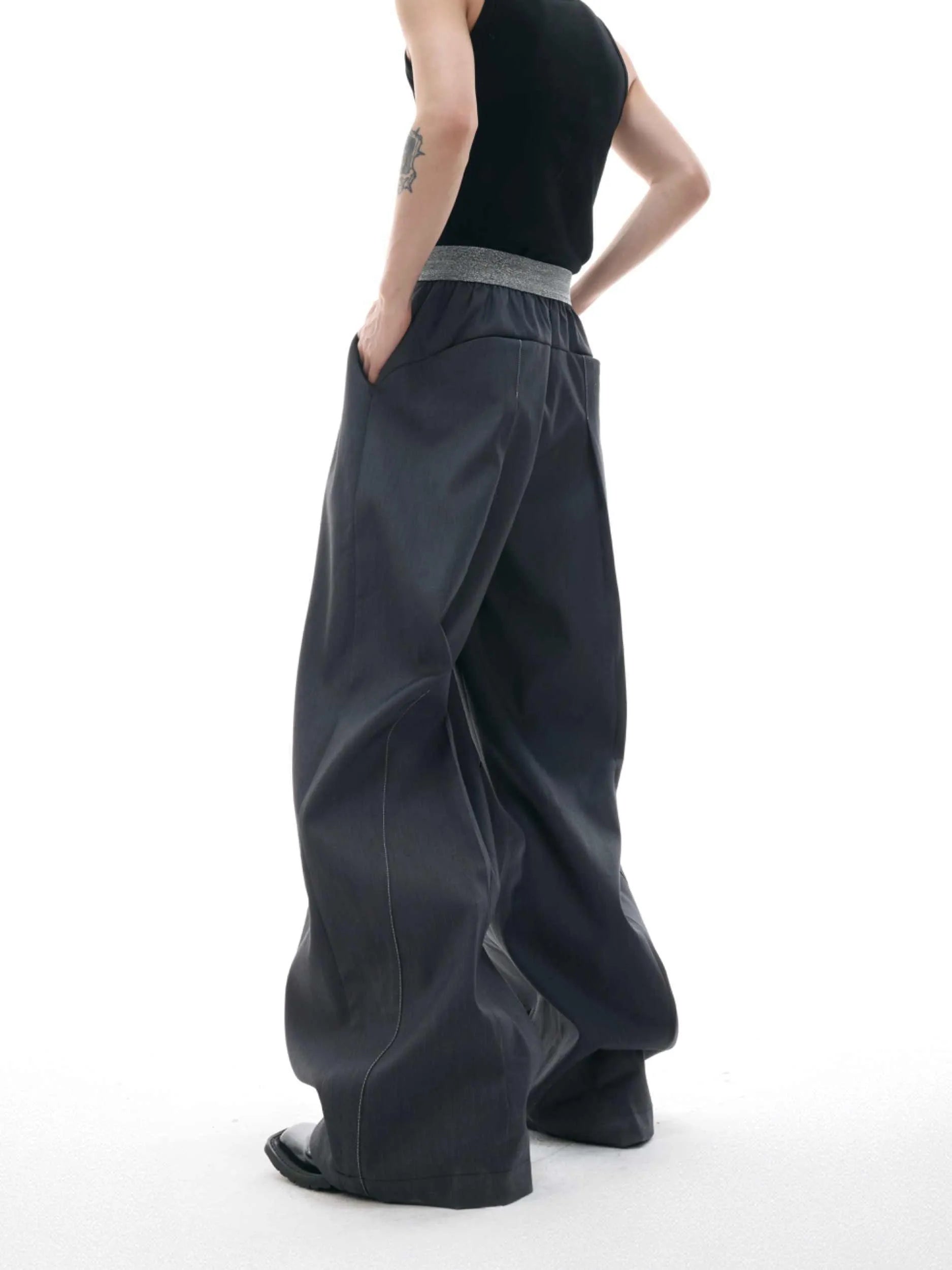 High-waist straight-leg trousers with a button detail on the leg in black or grey.